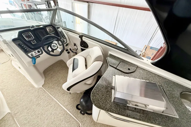 Slide: The Image of 2008 Chaparral Sunesta 284 boat interior with steering wheel and control panel. - 16