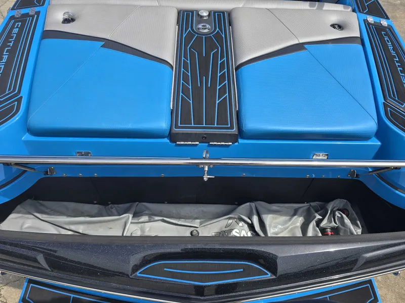 Slide: The Image of The image shows the rear of a 2022 Centurion Fi23 boat with blue and gray upholstery. - 18