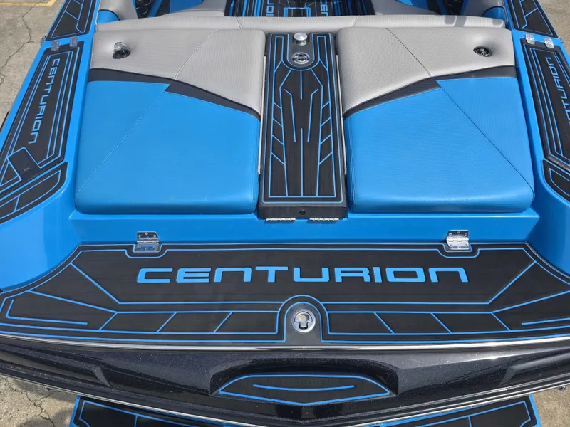 Slide: The Image of The image shows the rear of a 2022 Centurion Fi23 boat with blue and gray upholstery. - 17