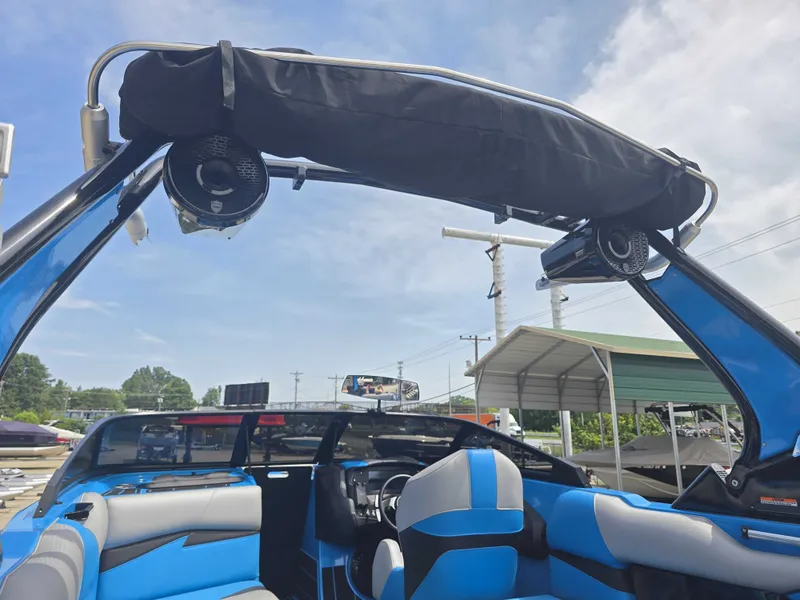 Slide: The Image of The image shows the interior of a 2022 Centurion Fi23 boat with blue seats and a black tower. - 16