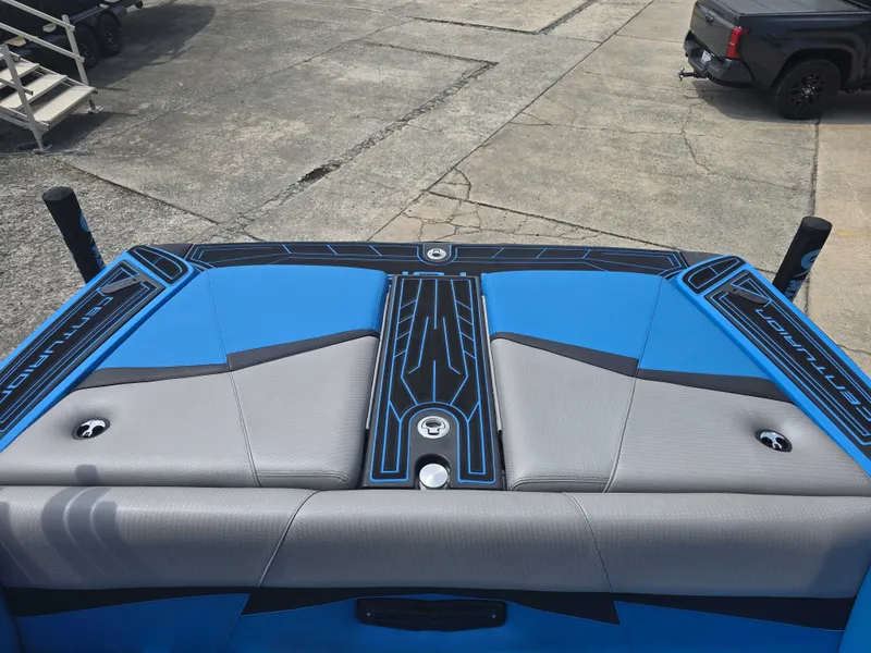 Slide: The Image of The image shows the rear of a 2022 Centurion Fi23 boat with blue and gray upholstery. - 14