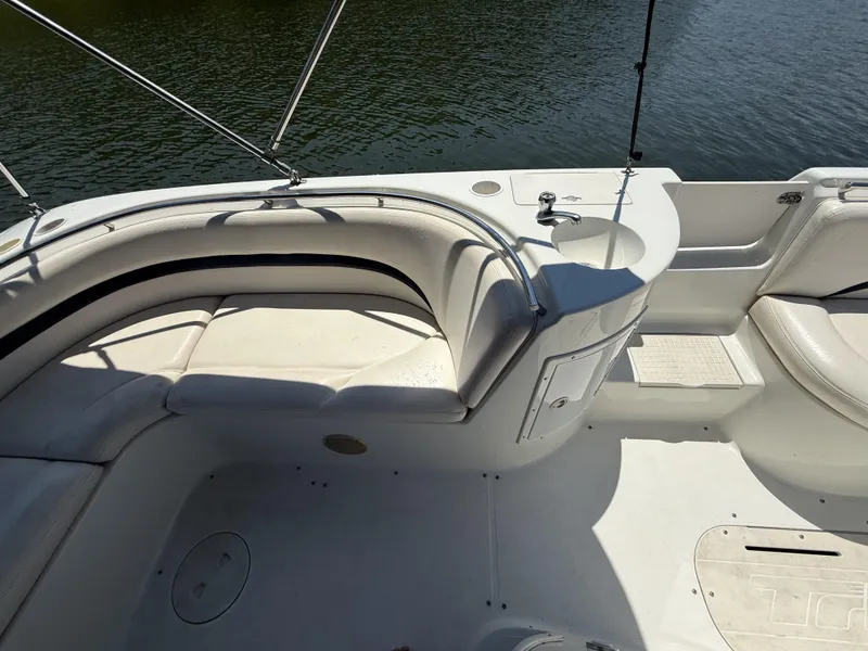 Slide: The Image of The image shows the cockpit of a 2001 Triton Elante 210 boat with white seating. - 16