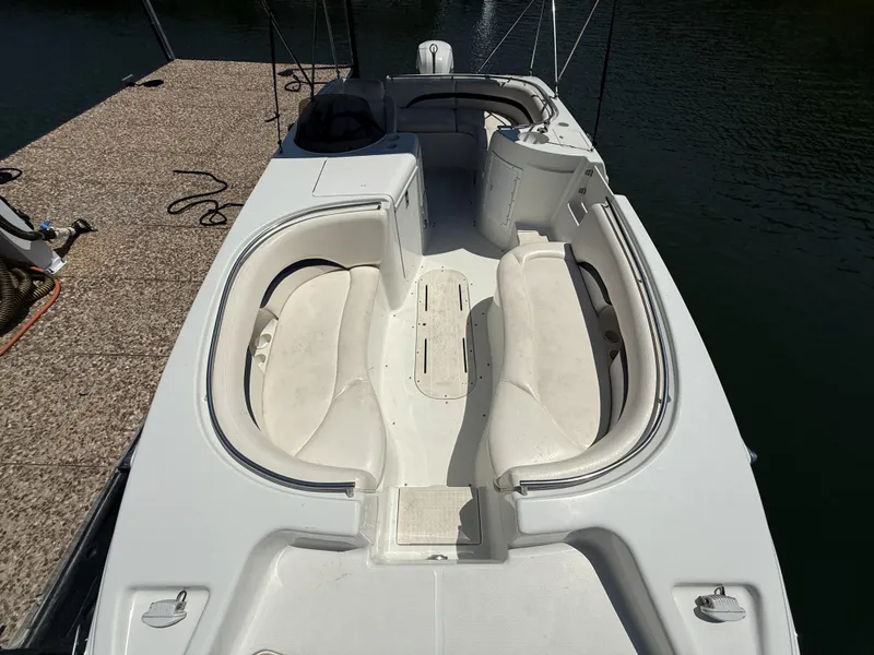Slide: The Image of The image shows the deck of a 2001 Triton Elante 210 boat with white seating. - 17