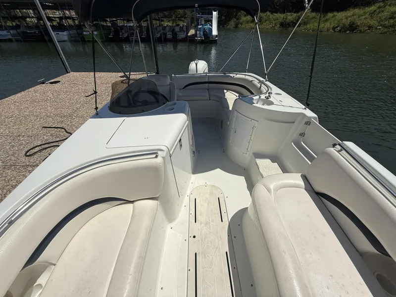 Slide: The Image of The image shows the deck of a 2001 Triton Elante 210 boat with white seating and a blue sunshade. - 20