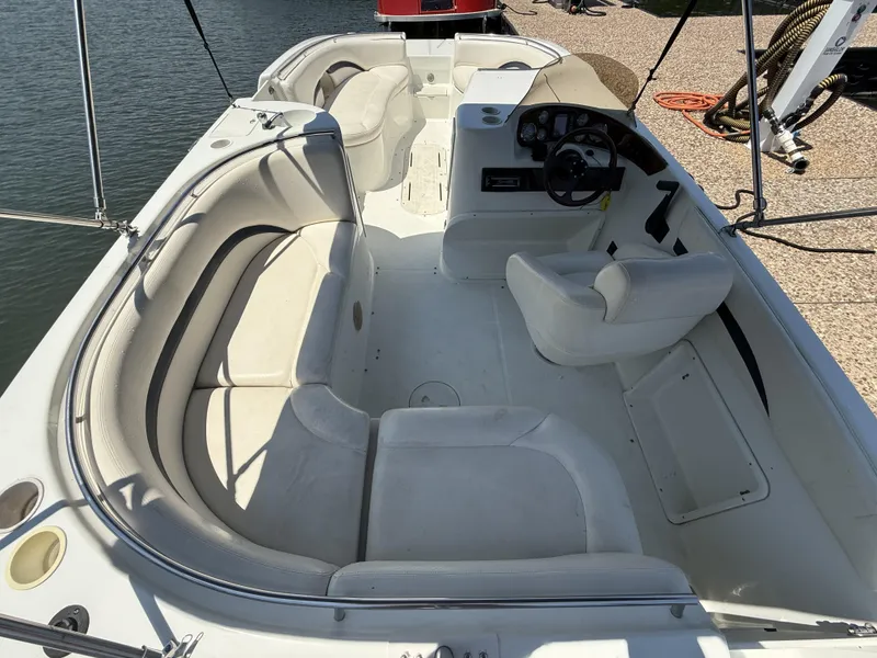 Slide: The Image of The image shows a 2001 Triton Elante 210 boat. It features white upholstery and an open cockpit design. - 14