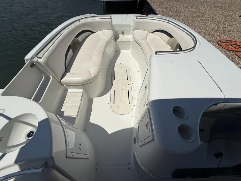 Slide: The Image of The image shows the cockpit of a 2001 Triton Elante 210 boat with white cushioned seating. - 18