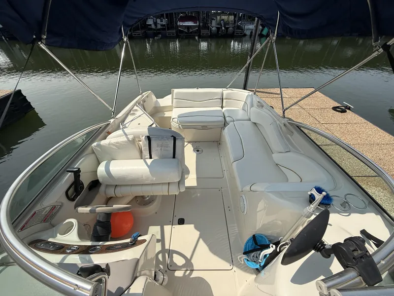 Slide: The Image of The image shows the cockpit of a 2000 Sea Ray 240 Sundeck with white seating and a blue canopy. - 17
