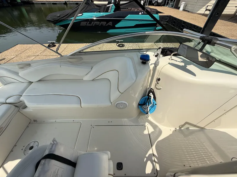Slide: The Image of The image shows the cockpit of a 2000 Sea Ray 240 Sundeck with white upholstery. - 18