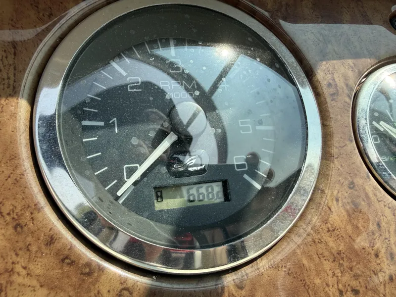 Slide: The Image of Close-up of a tachometer with wood trim, displaying 688 RPM. - 14