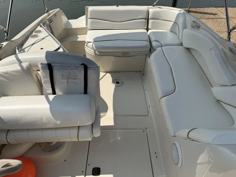 Slide: The Image of The image shows the spacious cockpit of a Sea Ray 240 Sundeck boat with white upholstery. - 7