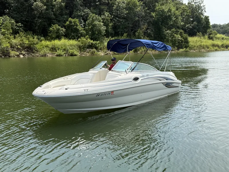 Slide: The Image of A 2000 Sea Ray 240 Sundeck cruising on a calm river with green banks. - 12