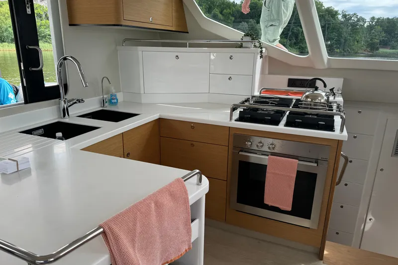 Slide: The Image of Modern yacht kitchen with sleek countertops, stove, and sink, Vision 444ES 2024 model. - 16