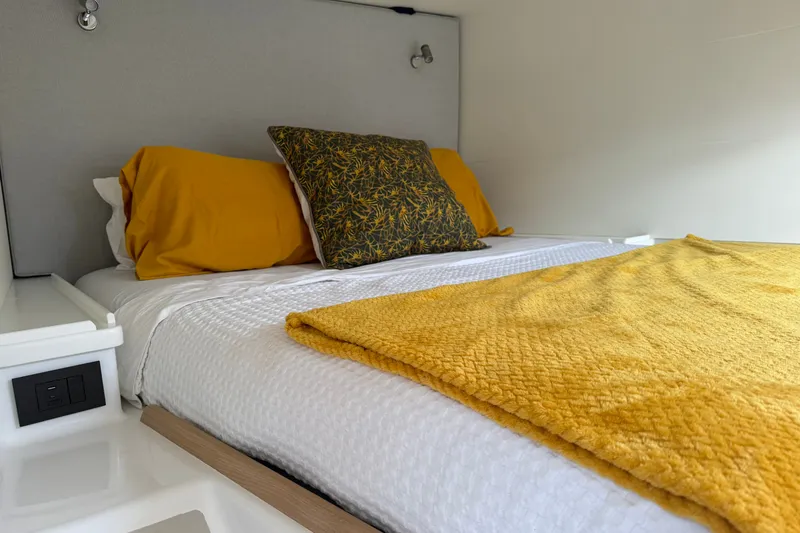 Slide: The Image of Cozy bed with yellow pillows and blanket in Vision 444ES, 2024 model. - 25
