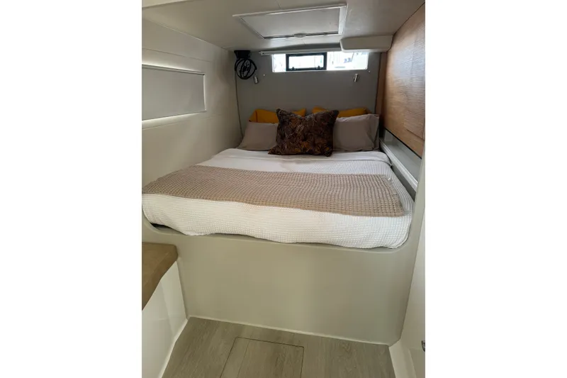 Slide: The Image of Cozy cabin interior of 2024 Vision 444ES with a neatly made bed. - 26