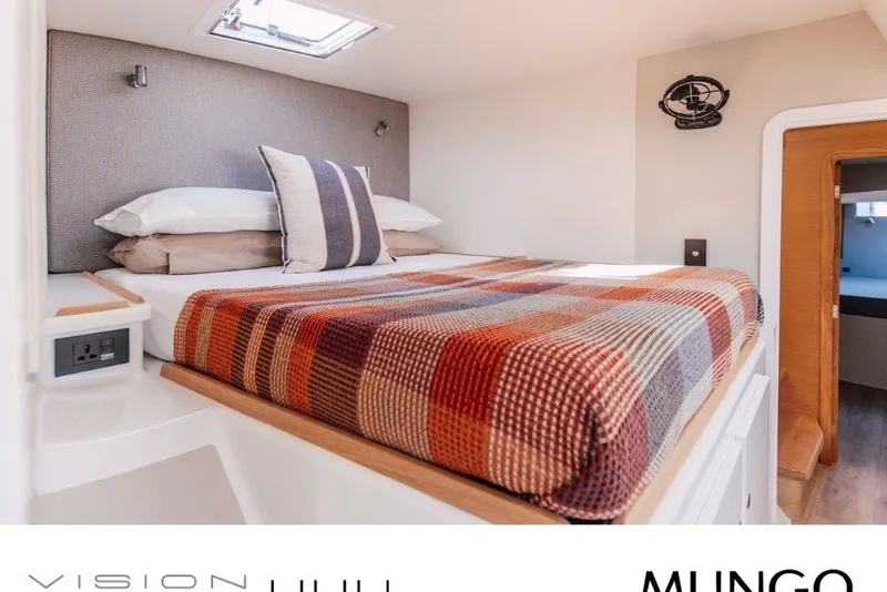 Slide: The Image of Cozy cabin interior of 2024 Vision 444ES with plaid bedding and modern design. - 21