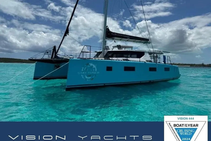 The Image of 2024 Vision 444ES catamaran sailing in clear turquoise waters under a partly cloudy sky. - 0