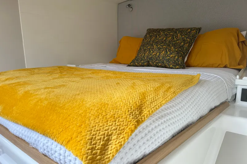 Slide: The Image of Cozy bed with yellow blanket and pillows in Vision 444ES, 2024 model. - 24
