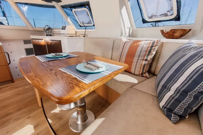 Slide: The Image of Luxurious interior of 2024 Vision 444ES yacht with elegant dining area and striped cushions. - 18