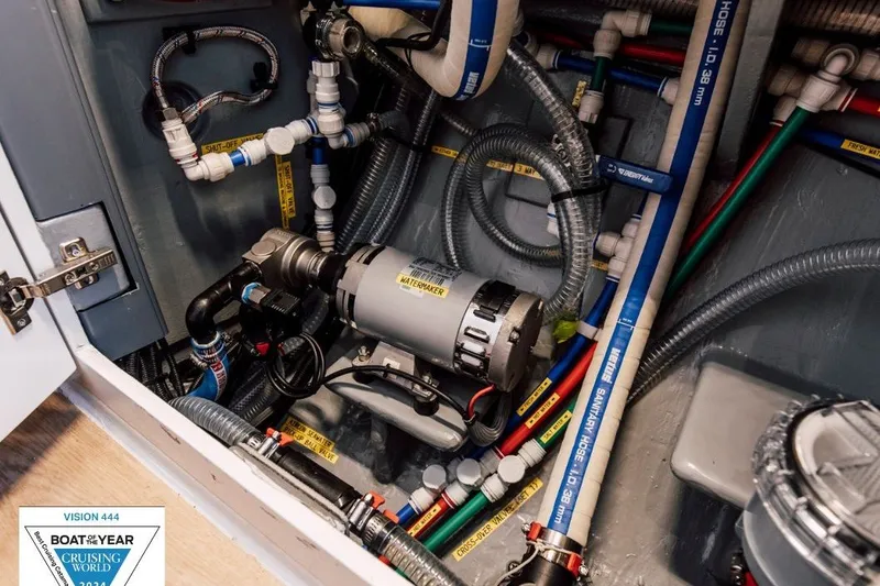 Slide: The Image of Engine compartment of 2024 Vision 444ES boat, showcasing intricate plumbing and wiring systems. - 35