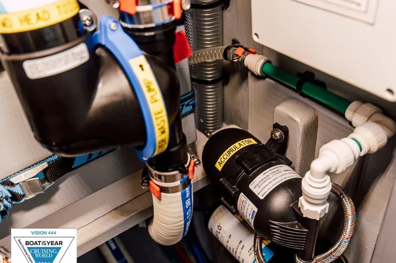 Slide: The Image of Plumbing system inside Vision 444ES boat, featuring waste pump and accumulator, 2024 model. - 34