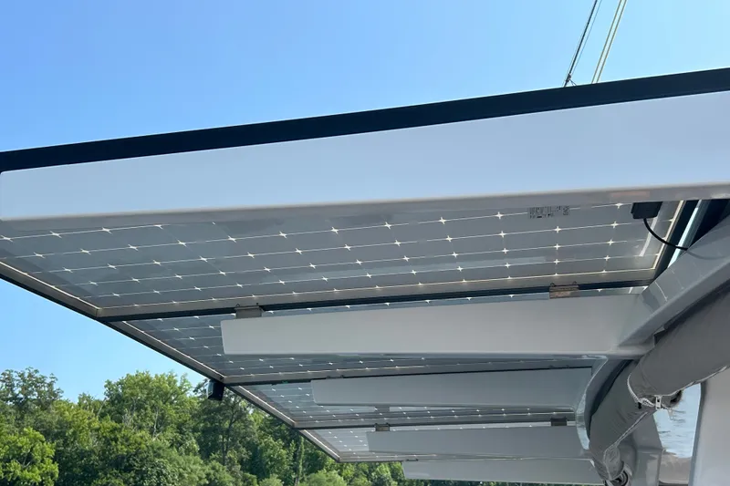 Slide: The Image of Solar panels on Vision 444ES yacht, 2024 model, under clear blue sky. - 13