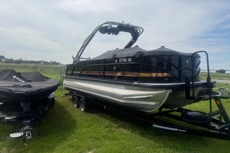 The Image of 2023 Berkshire 23ULE STS pontoon boat on trailer, parked on grass. - 1