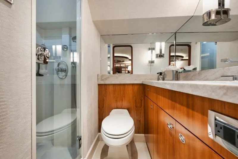 Slide: The Image of Luxurious bathroom in 2003 Westport 112 yacht with modern fixtures and wooden cabinetry. - 21