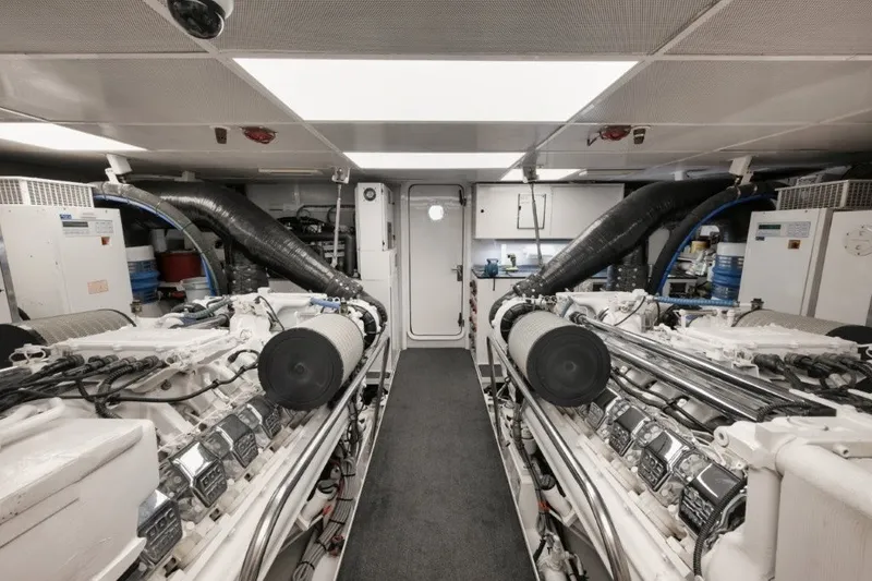 Slide: The Image of Engine room of 2003 Westport 112 Raised Pilothouse yacht, featuring dual engines and equipment. - 43