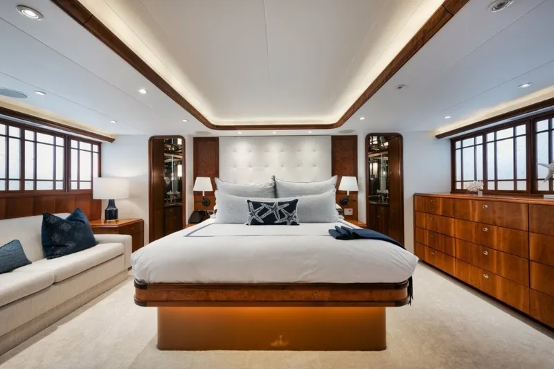 Slide: The Image of Luxurious bedroom interior on 2003 Westport 112 Raised Pilothouse yacht, featuring elegant wood accents. - 13