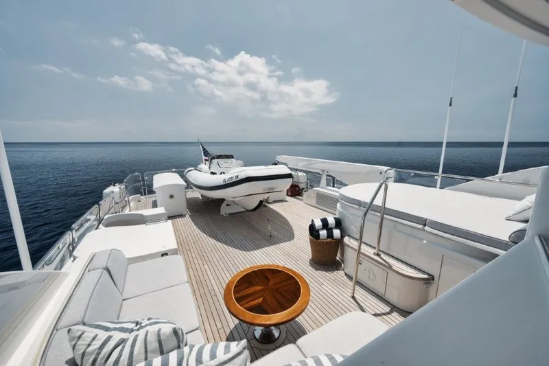 Slide: The Image of Luxurious deck of 2003 Westport 112 yacht with seating, table, and ocean view. - 33