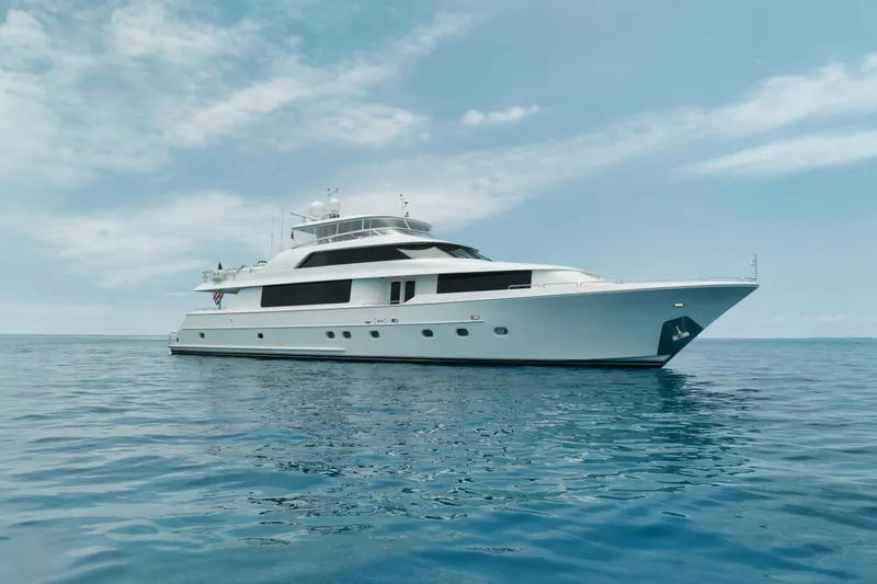 The Image of Luxurious 2003 Westport 112 yacht on calm ocean waters under a clear sky. - 0