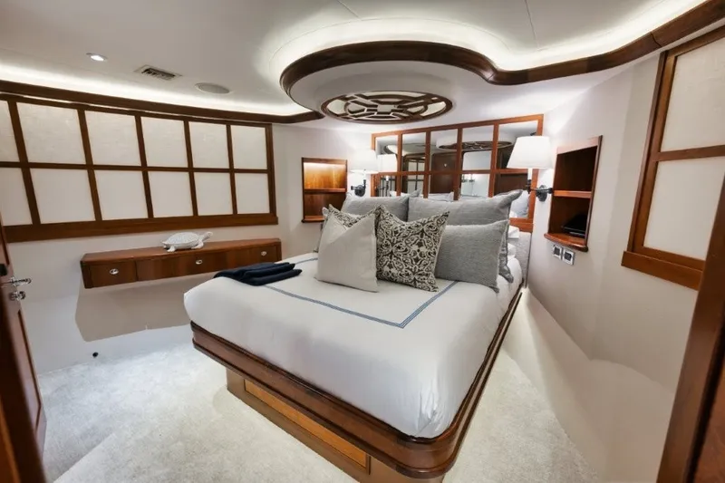 Slide: The Image of Luxurious bedroom interior of 2003 Westport 112 Raised Pilothouse yacht with elegant wood accents. - 19