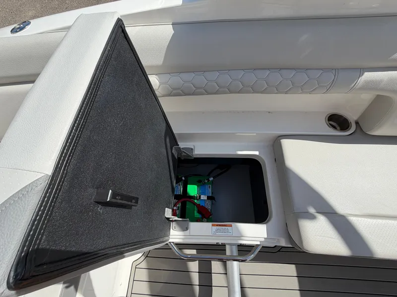Slide: The Image of An open storage compartment on a 2025 Sea Ray SDX 290 boat reveals batteries and wiring. - 22