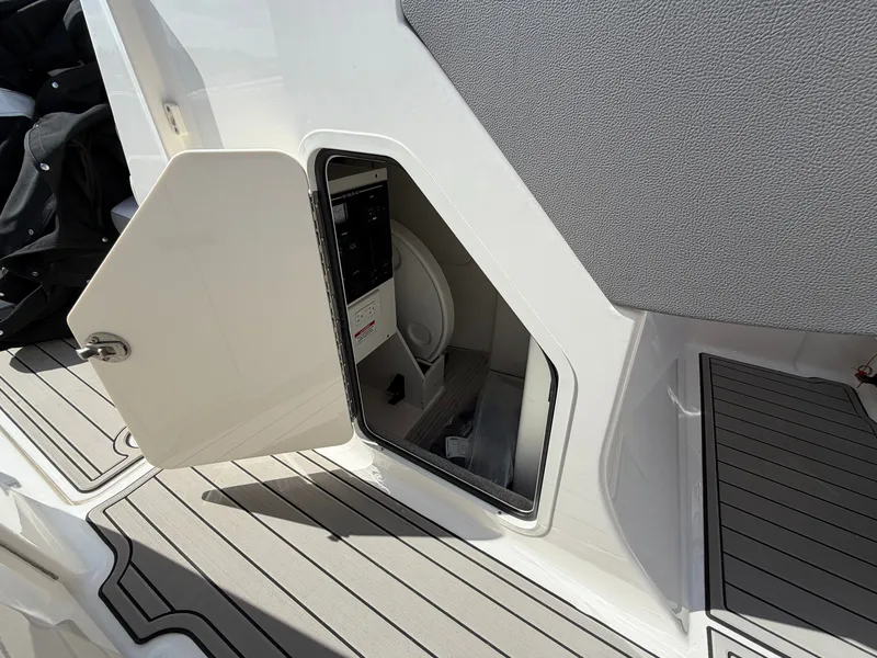 Slide: The Image of An open storage compartment on a 2025 Sea Ray SDX 290 boat. - 48