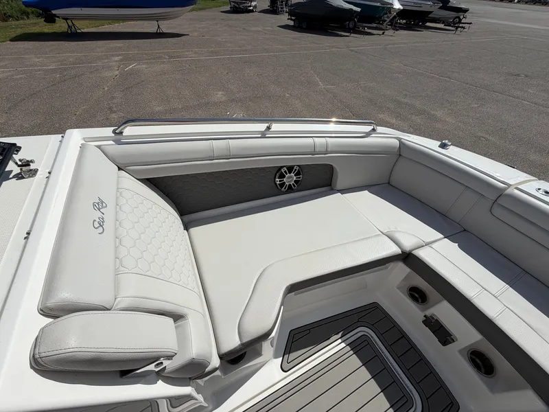 Slide: The Image of The image shows the cockpit of a 2025 Sea Ray SDX 290 with sleek white upholstery. - 50