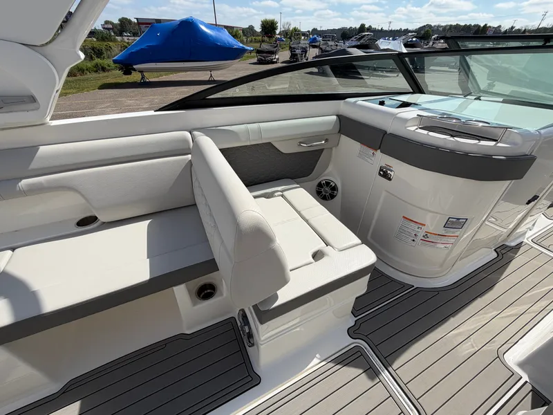 Slide: The Image of The image shows the cockpit of a 2025 Sea Ray SDX 290 boat with white seating. - 25