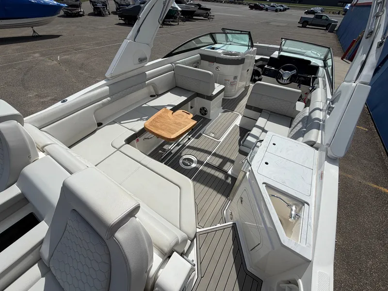 Slide: The Image of The image shows the spacious cockpit of a 2025 Sea Ray SDX 290 with sleek white seating. - 14