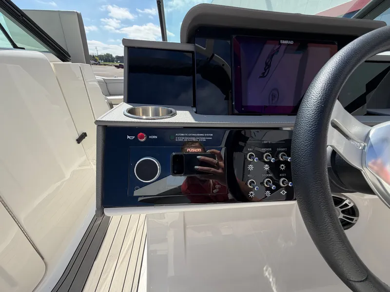 Slide: The Image of The image shows the helm of a Sea Ray SDX 290 boat with modern instruments. - 45