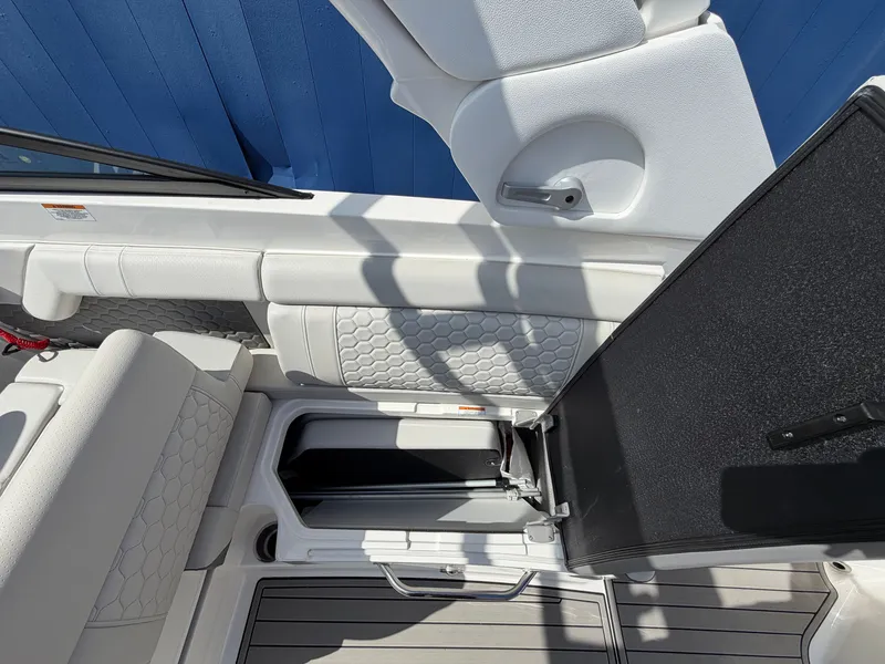 Slide: The Image of Interior of the 2025 Sea Ray SDX 290 with white upholstery and storage space. - 21