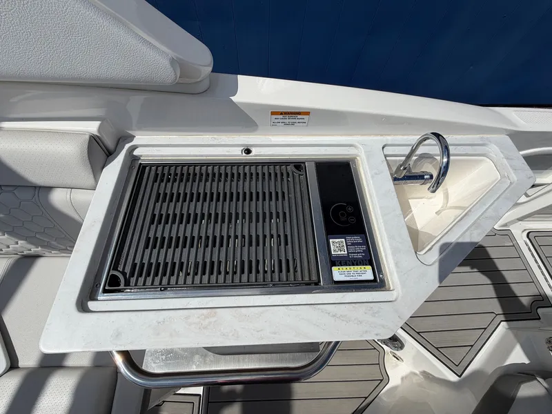 Slide: The Image of The 2025 Sea Ray SDX 290 features an outdoor kitchen with a grill and sink. - 17