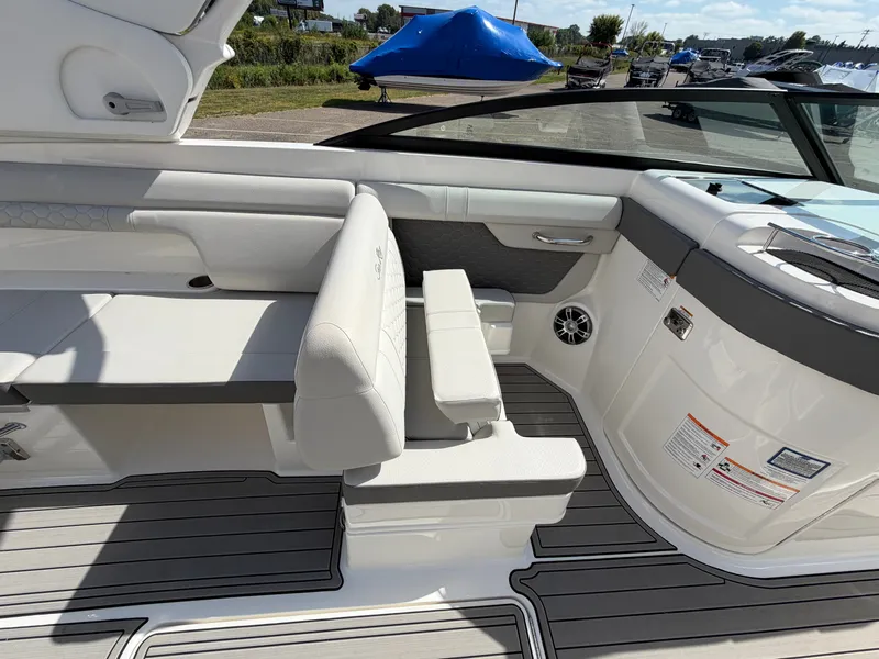 Slide: The Image of The image shows the cockpit of a 2025 Sea Ray SDX 290 with sleek seating and gray flooring. - 29