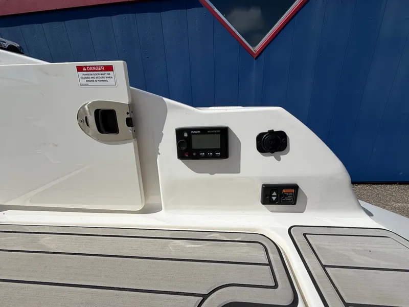 Slide: The Image of The image shows the cockpit of a 2025 Sea Ray SDX 290 with controls and instruments. - 15