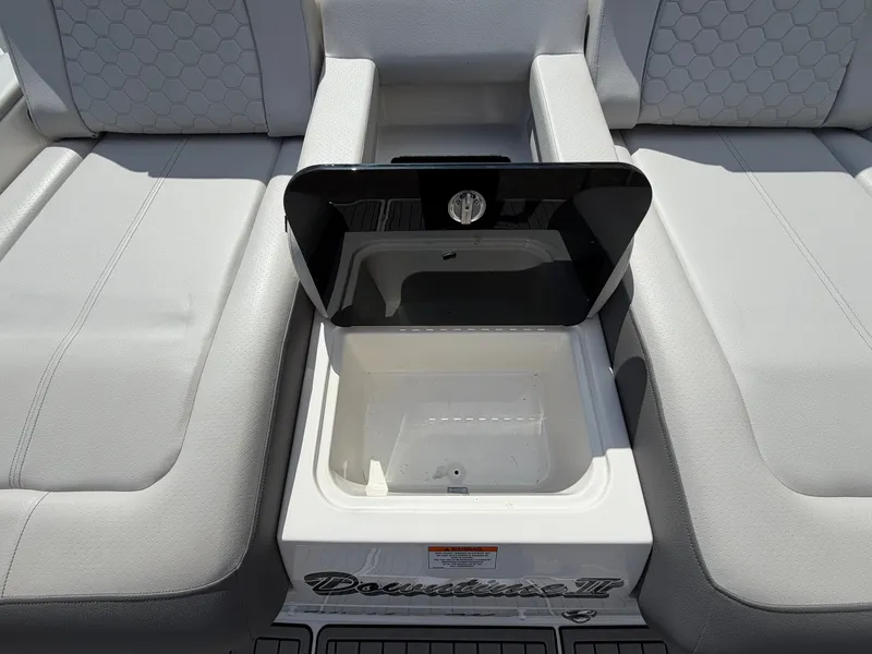 Slide: The Image of The image shows the seating area of a Sea Ray SDX 290 boat with a built-in cooler. - 9