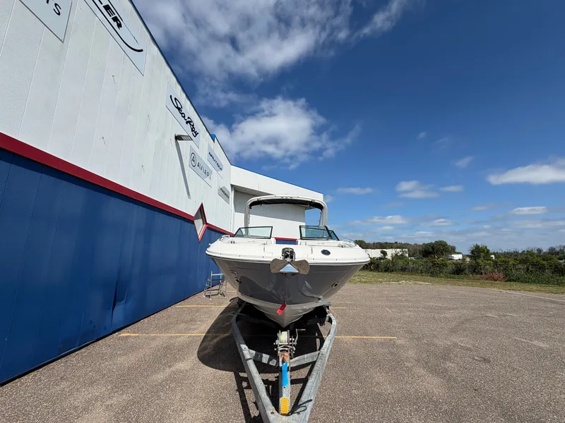 Slide: The Image of A 2025 Sea Ray SDX 290 boat on a trailer in front of a building. - 3