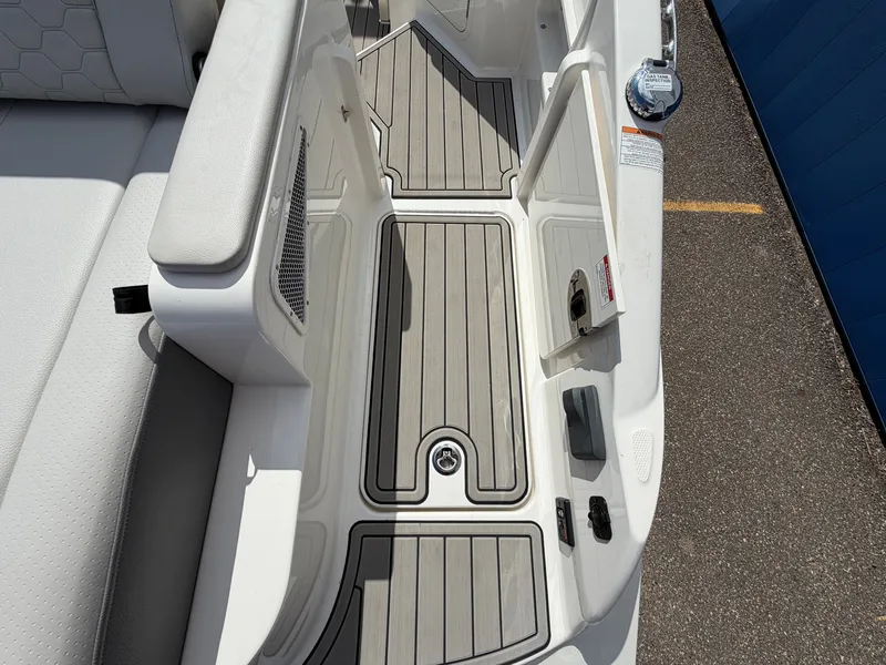 Slide: The Image of The image shows the deck of a 2025 Sea Ray SDX 290 boat with gray flooring. - 12