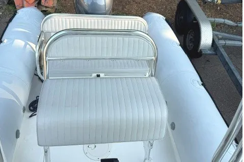 The Image of 2021 Ribcraft 5.85 inflatable boat with white seating and trailer. - 1