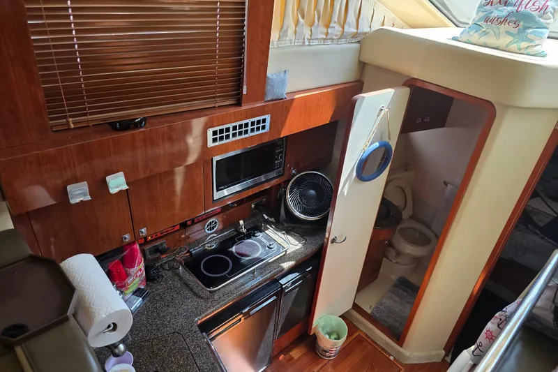 Slide: The Image of 2007 Sea Ray 36 Sedan Bridge interior with kitchen and bathroom view. - 6