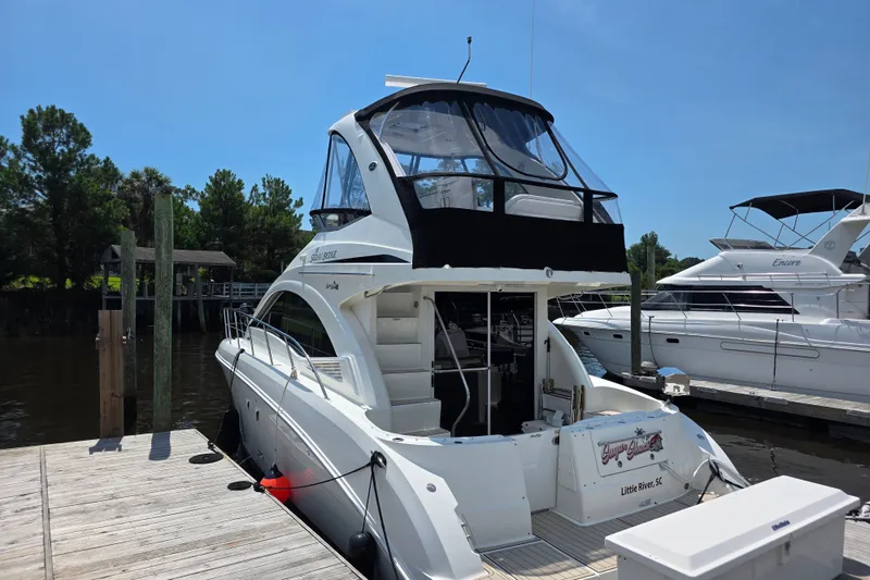 Slide: The Image of 2007 Sea Ray 36 Sedan Bridge yacht docked at marina under clear blue sky. - 4
