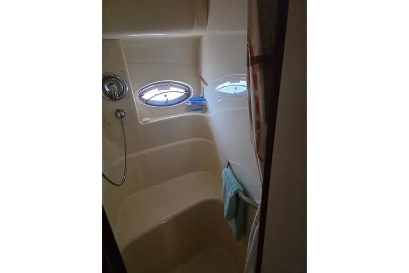 Slide: The Image of Bathroom interior of 2007 Sea Ray 36 Sedan Bridge yacht with porthole window. - 12