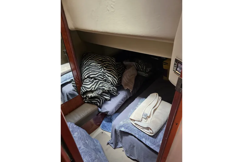 Slide: The Image of Cozy cabin interior of 2007 Sea Ray 36 Sedan Bridge with bedding and towels. - 10